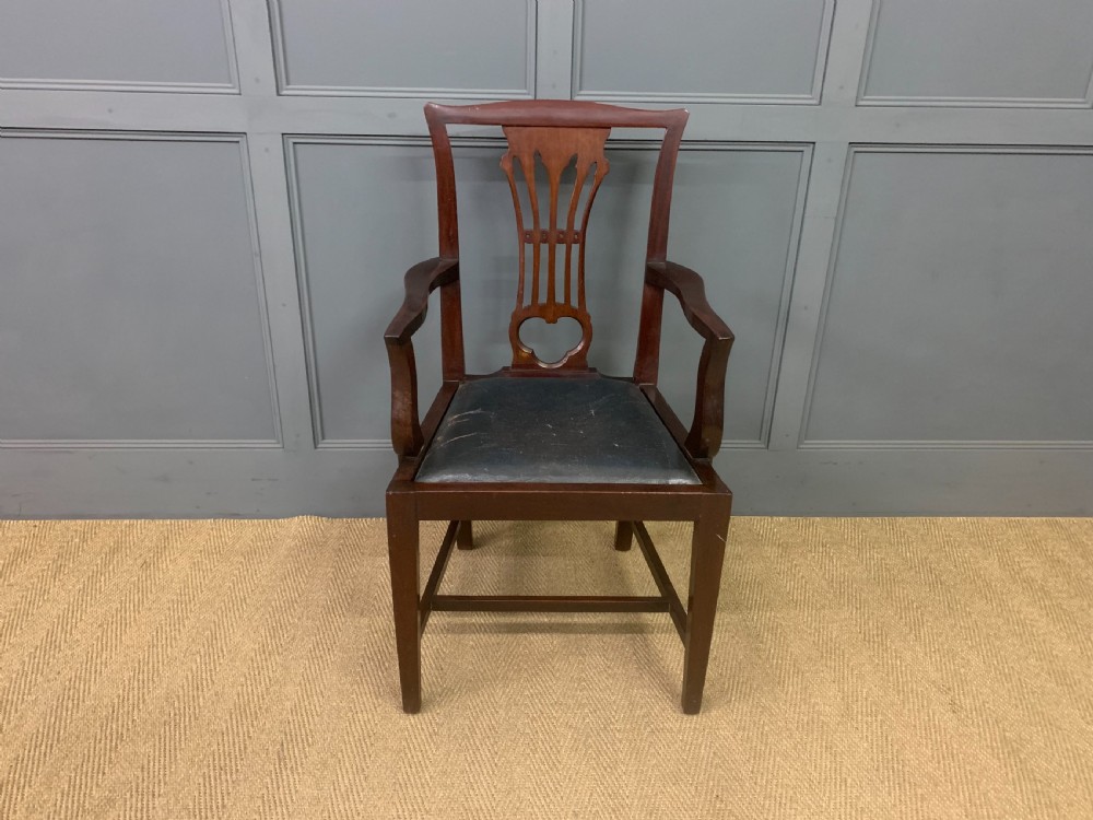 A 19th-century dark mahogany open armchair featuring a carved pierced back splat, swept armrests, and a blue drop-in upholstered seat. View II