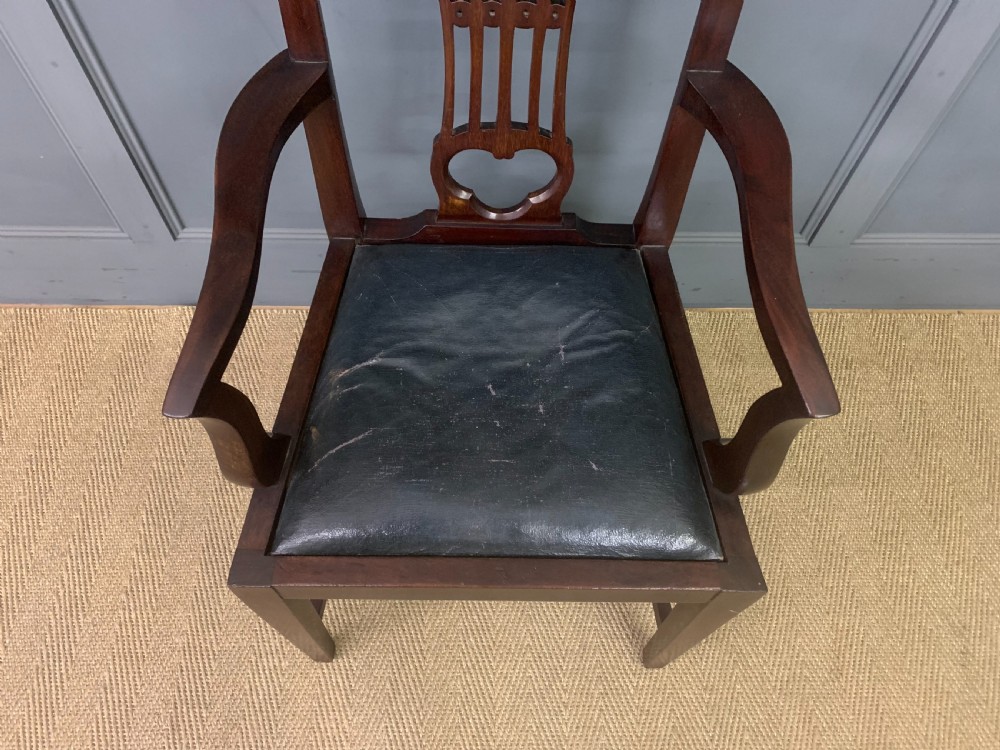 A 19th-century dark mahogany open armchair featuring a carved pierced back splat, swept armrests, and a blue drop-in upholstered seat. View III