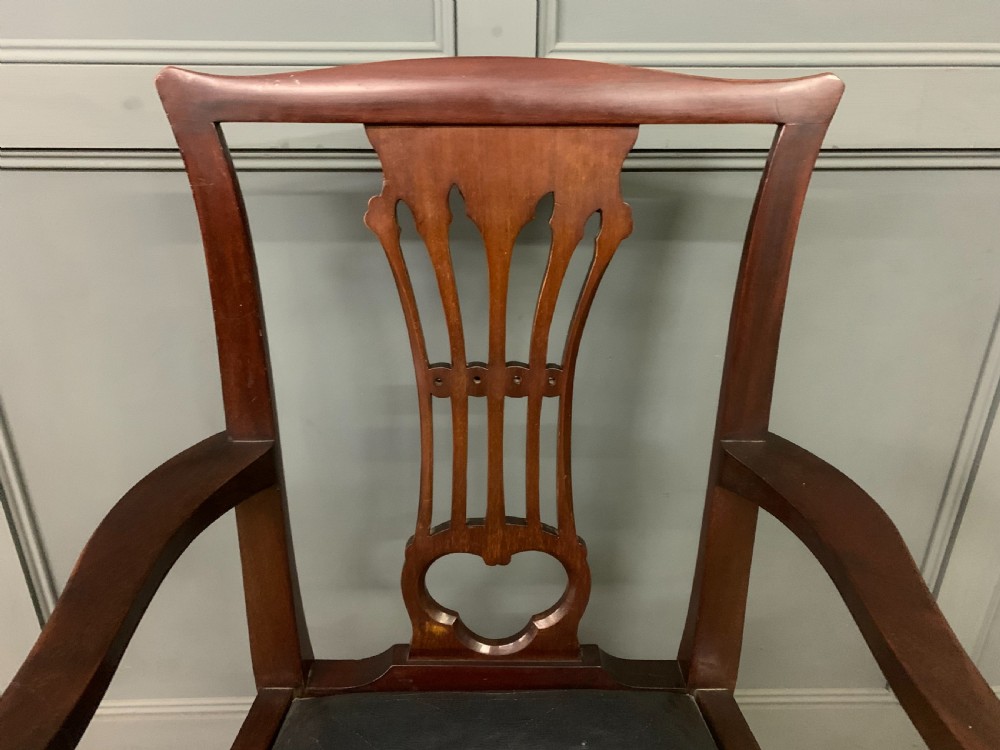 A 19th-century dark mahogany open armchair featuring a carved pierced back splat, swept armrests, and a blue drop-in upholstered seat. View IV