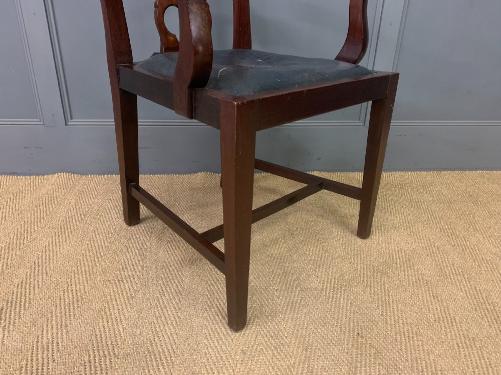 A 19th-century dark mahogany open armchair featuring a carved pierced back splat, swept armrests, and a blue drop-in upholstered seat. View V