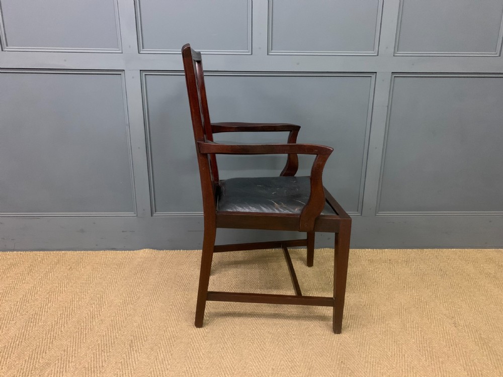 A 19th-century dark mahogany open armchair featuring a carved pierced back splat, swept armrests, and a blue drop-in upholstered seat. View VII