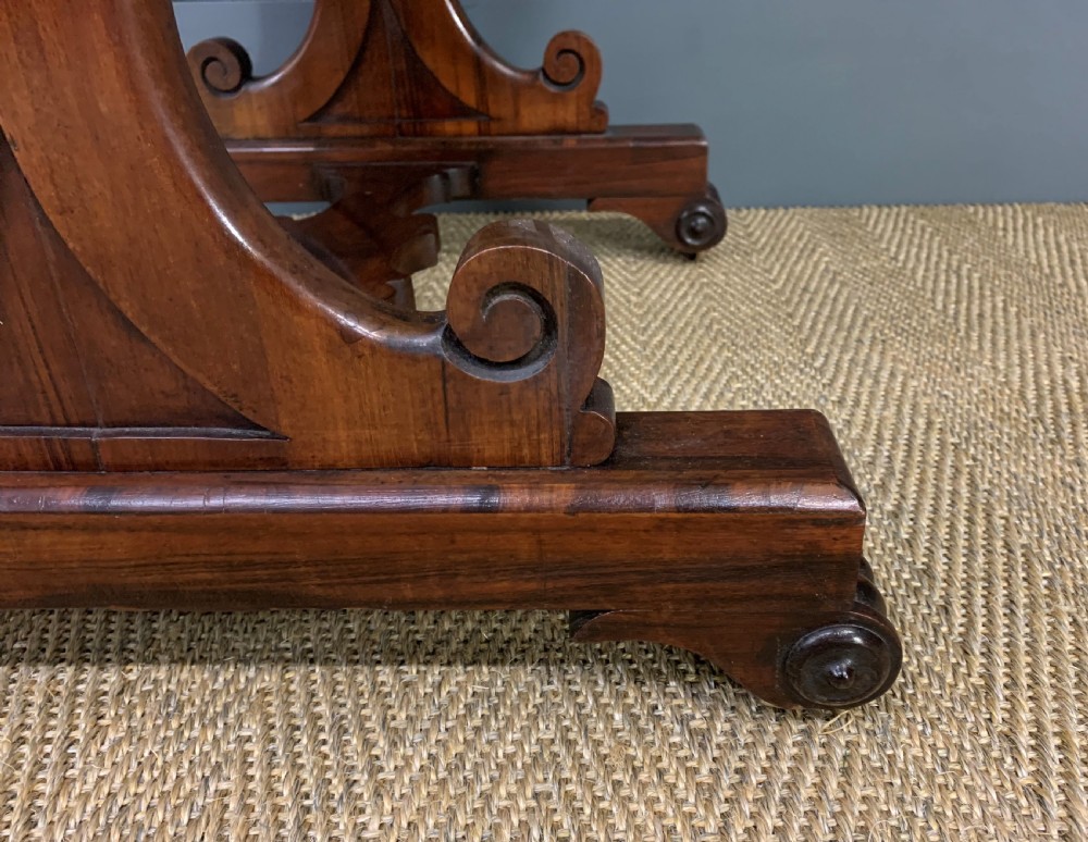 A William IV rosewood work table featuring a figured square top, pleated cream fabric basket, and carved scroll supports. View XIV