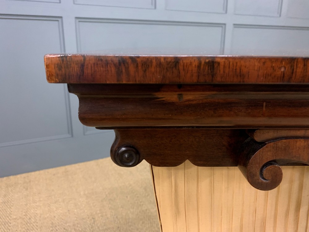 A William IV rosewood work table featuring a figured square top, pleated cream fabric basket, and carved scroll supports. View XV