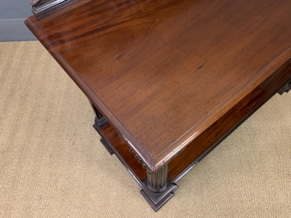 A Victorian mahogany buffet featuring a carved scroll backboard, two frieze drawers with brass handles, fluted support columns, and an open lower tier. View XIII