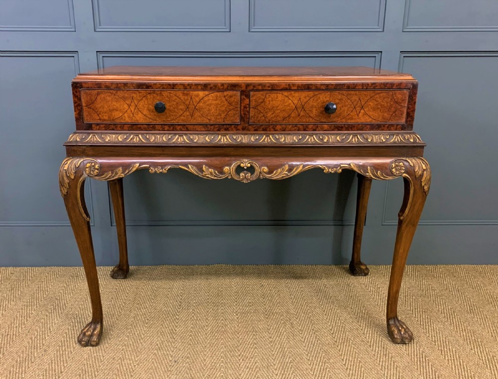 A burr walnut side table featuring two drawers with feather banding, carved egg-and-dart moulding, gilded accents, cabriole legs, and ball-and-claw feet. View III