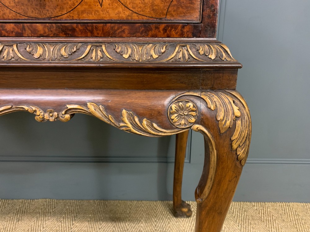 A burr walnut side table featuring two drawers with feather banding, carved egg-and-dart moulding, gilded accents, cabriole legs, and ball-and-claw feet. View VI