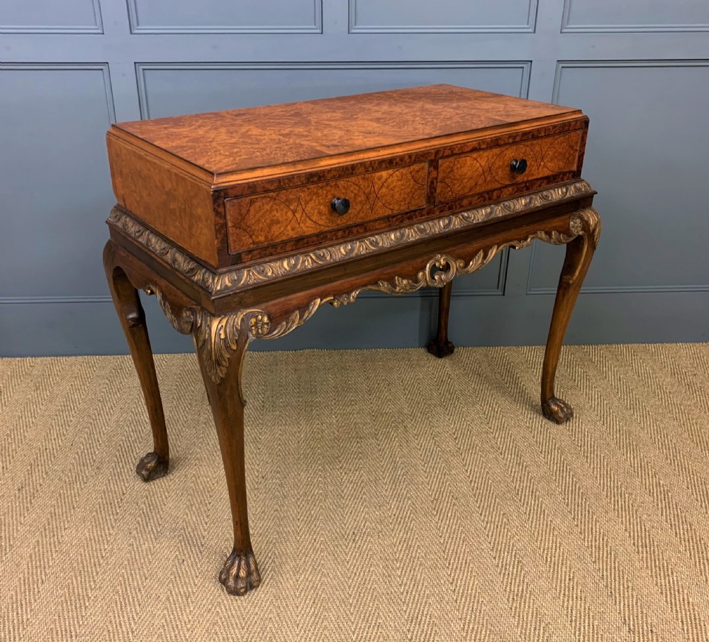 A burr walnut side table featuring two drawers with feather banding, carved egg-and-dart moulding, gilded accents, cabriole legs, and ball-and-claw feet. View VIII