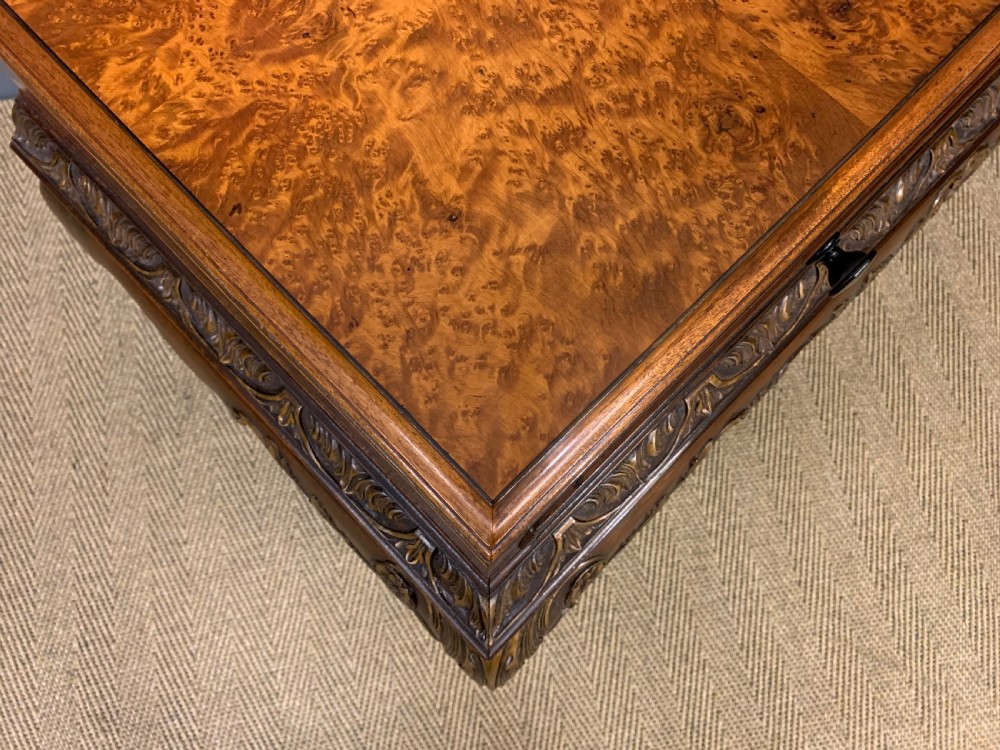 A burr walnut side table featuring two drawers with feather banding, carved egg-and-dart moulding, gilded accents, cabriole legs, and ball-and-claw feet. View X