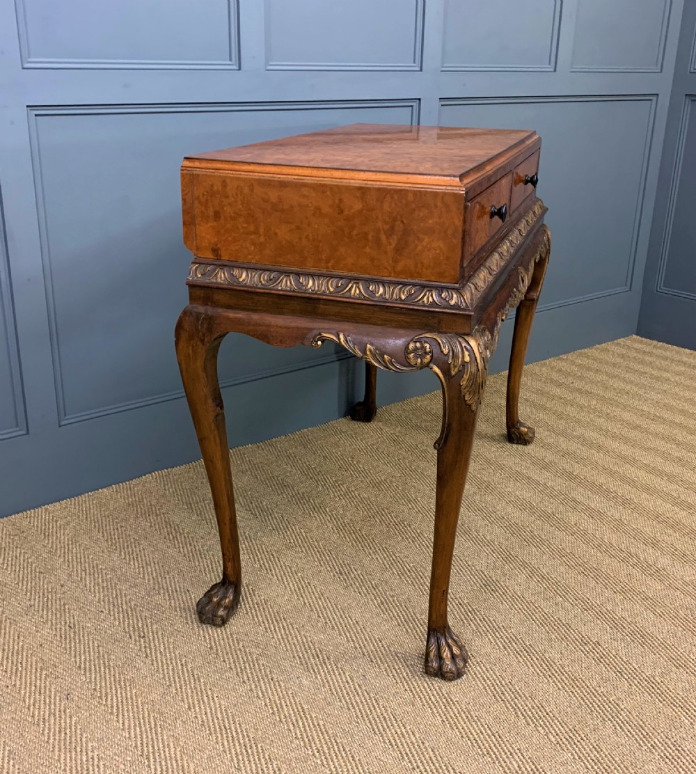 A burr walnut side table featuring two drawers with feather banding, carved egg-and-dart moulding, gilded accents, cabriole legs, and ball-and-claw feet. View XI