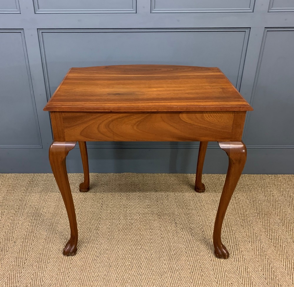 A warm brown burr walnut side table featuring a curved drawer front with brass handles and carved cabriole legs. View XII