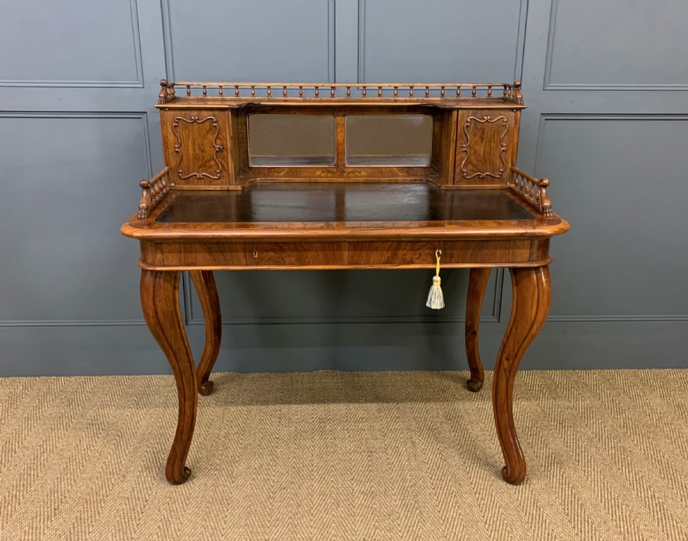 A 19th-century burr walnut bonheur du jour writing desk with a dark leather top, slender cabriole legs, and a gallery section featuring mirrors and small side cabinets. View II