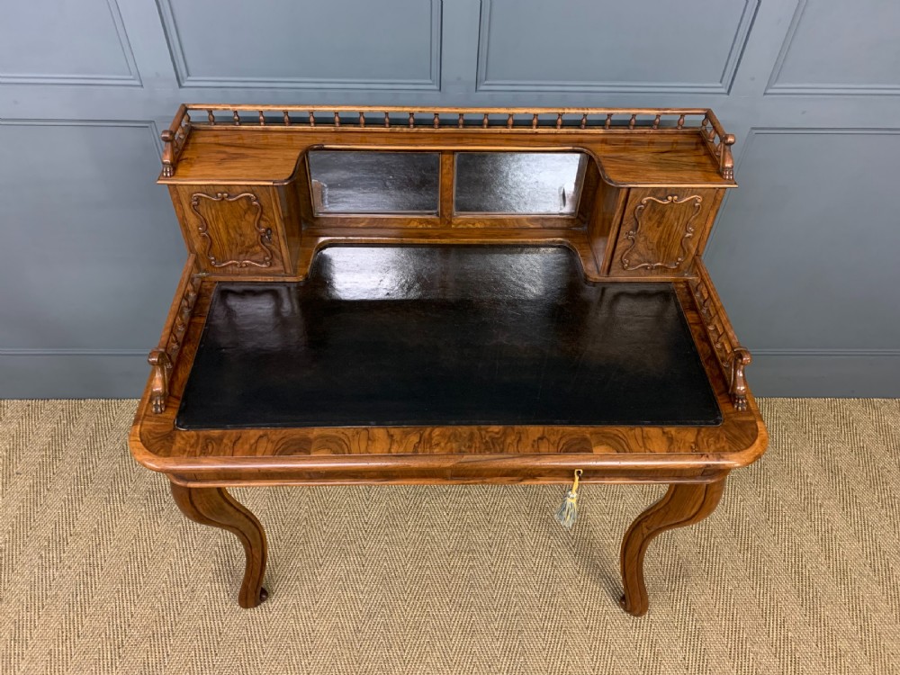A 19th-century burr walnut bonheur du jour writing desk with a dark leather top, slender cabriole legs, and a gallery section featuring mirrors and small side cabinets. View III
