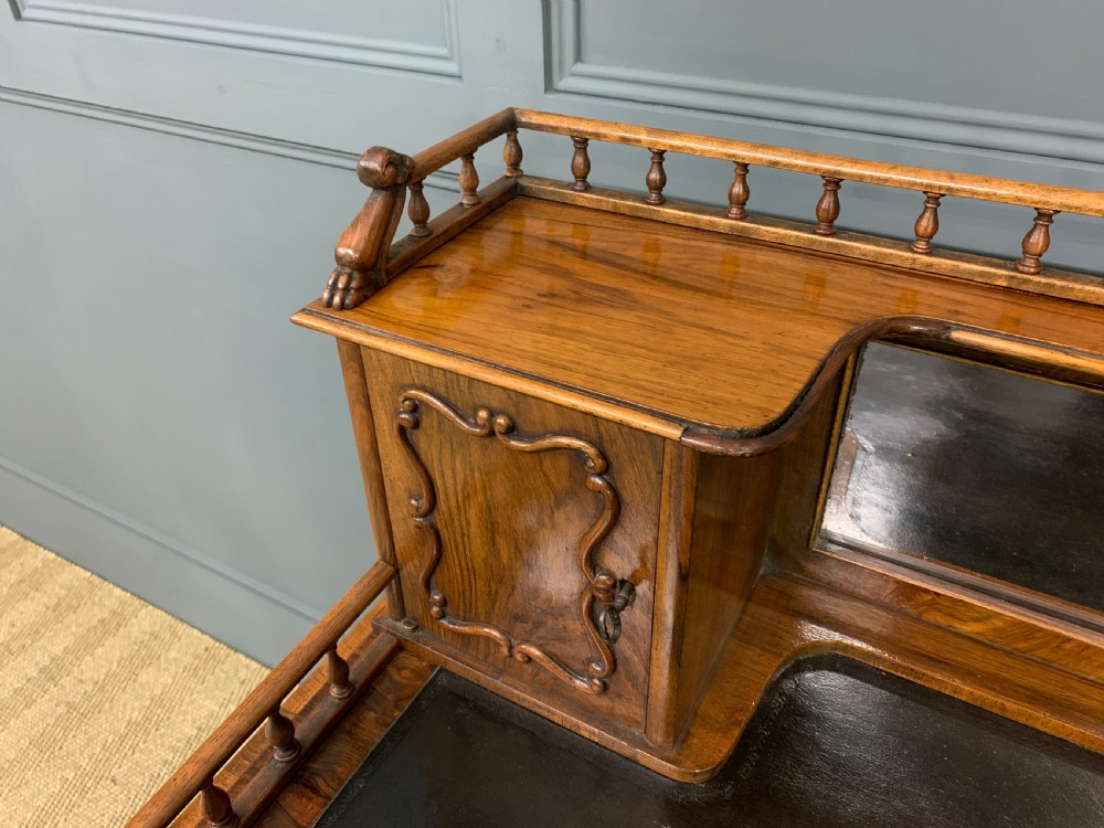 A 19th-century burr walnut bonheur du jour writing desk with a dark leather top, slender cabriole legs, and a gallery section featuring mirrors and small side cabinets. View VII