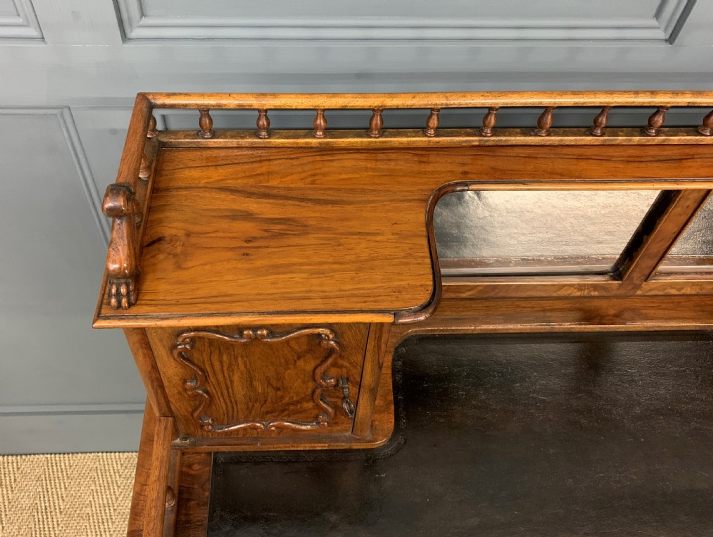 A 19th-century burr walnut bonheur du jour writing desk with a dark leather top, slender cabriole legs, and a gallery section featuring mirrors and small side cabinets. View VIII