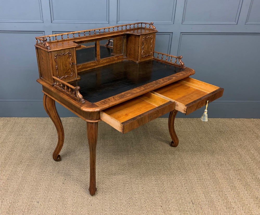 A 19th-century burr walnut bonheur du jour writing desk with a dark leather top, slender cabriole legs, and a gallery section featuring mirrors and small side cabinets. View XIII