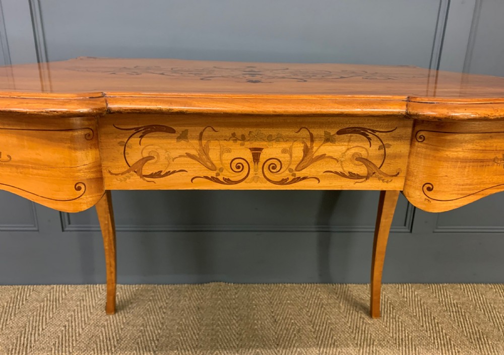 A 19th-century satinwood side table featuring floral marquetry inlay, serpentine edges, curved cabriole legs, and brass corner mounts. View VIII