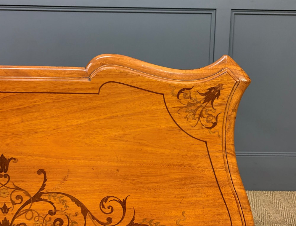 A 19th-century satinwood side table featuring floral marquetry inlay, serpentine edges, curved cabriole legs, and brass corner mounts. View XVI