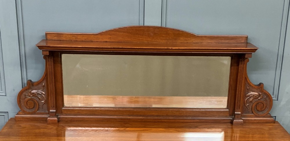 A Victorian walnut hall cupboard featuring a mirror back, two frieze drawers, panelled lower doors, and integrated side umbrella stands with brass rails. View VIII