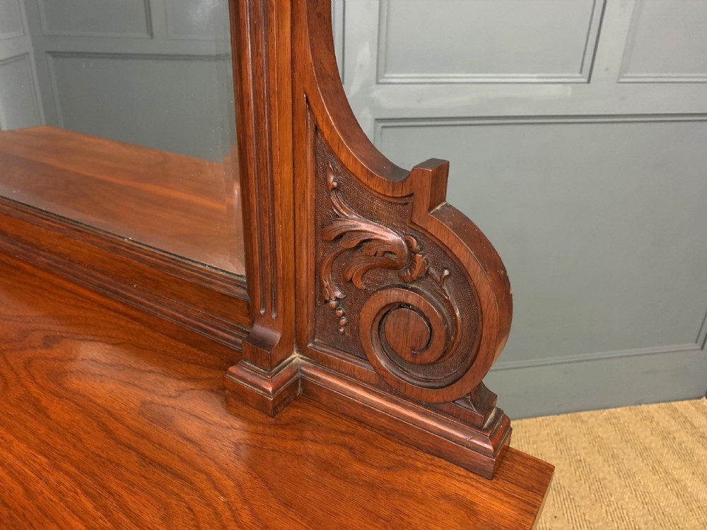 A Victorian walnut hall cupboard featuring a mirror back, two frieze drawers, panelled lower doors, and integrated side umbrella stands with brass rails. View XIV