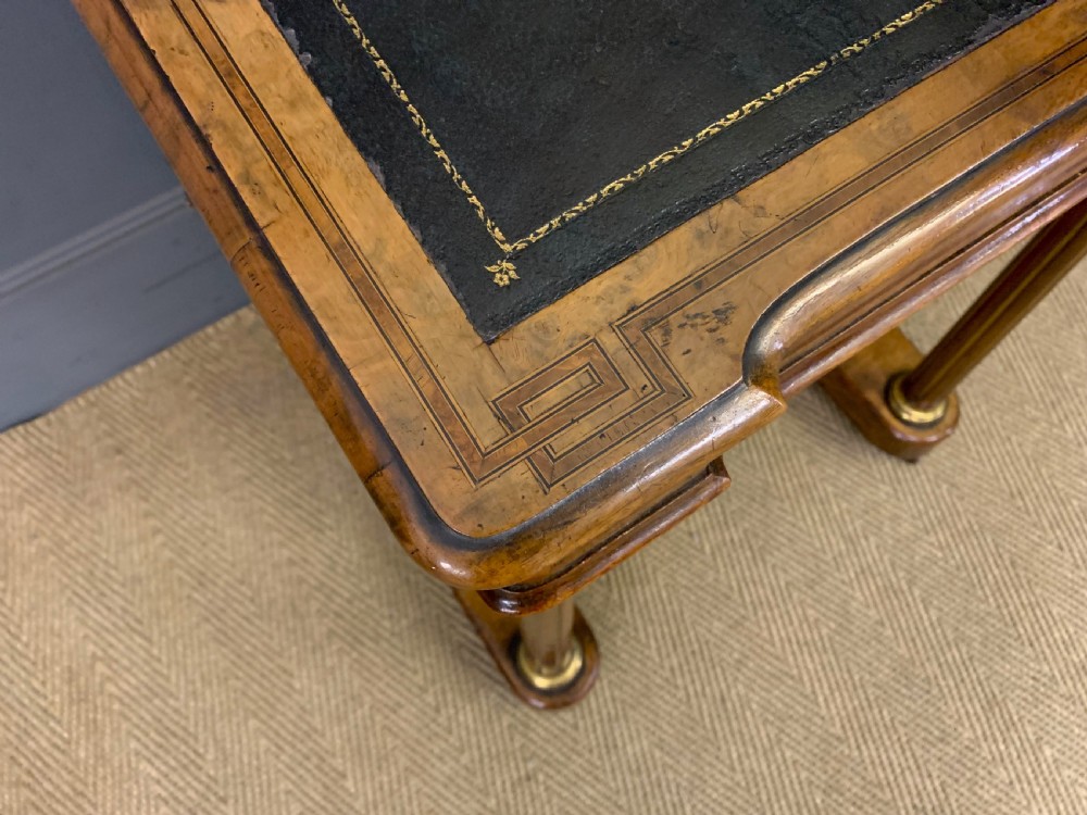 A Victorian burr walnut davenport desk featuring a sloped dark leather inset writing surface, brass gallery rail, side drawers, and fluted column supports. View IV