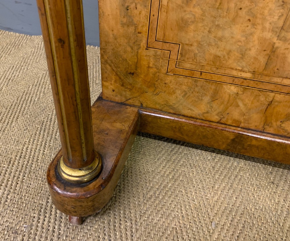 A Victorian burr walnut davenport desk featuring a sloped dark leather inset writing surface, brass gallery rail, side drawers, and fluted column supports. View VII