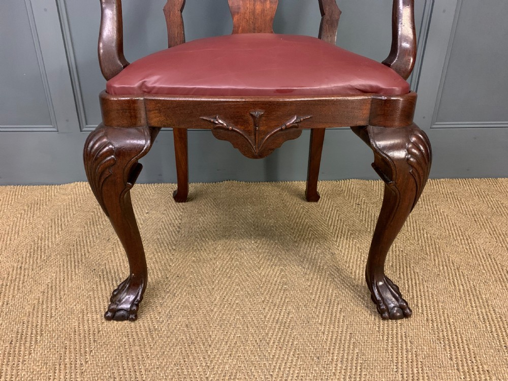 A walnut high-back armchair featuring a carved back splat, reddish-brown leather seat, shaped arms, and carved cabriole legs ending in claw and ball feet. View III