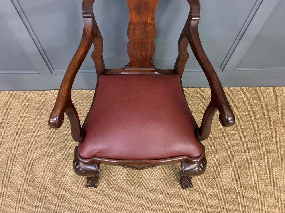 A walnut high-back armchair featuring a carved back splat, reddish-brown leather seat, shaped arms, and carved cabriole legs ending in claw and ball feet. View IV