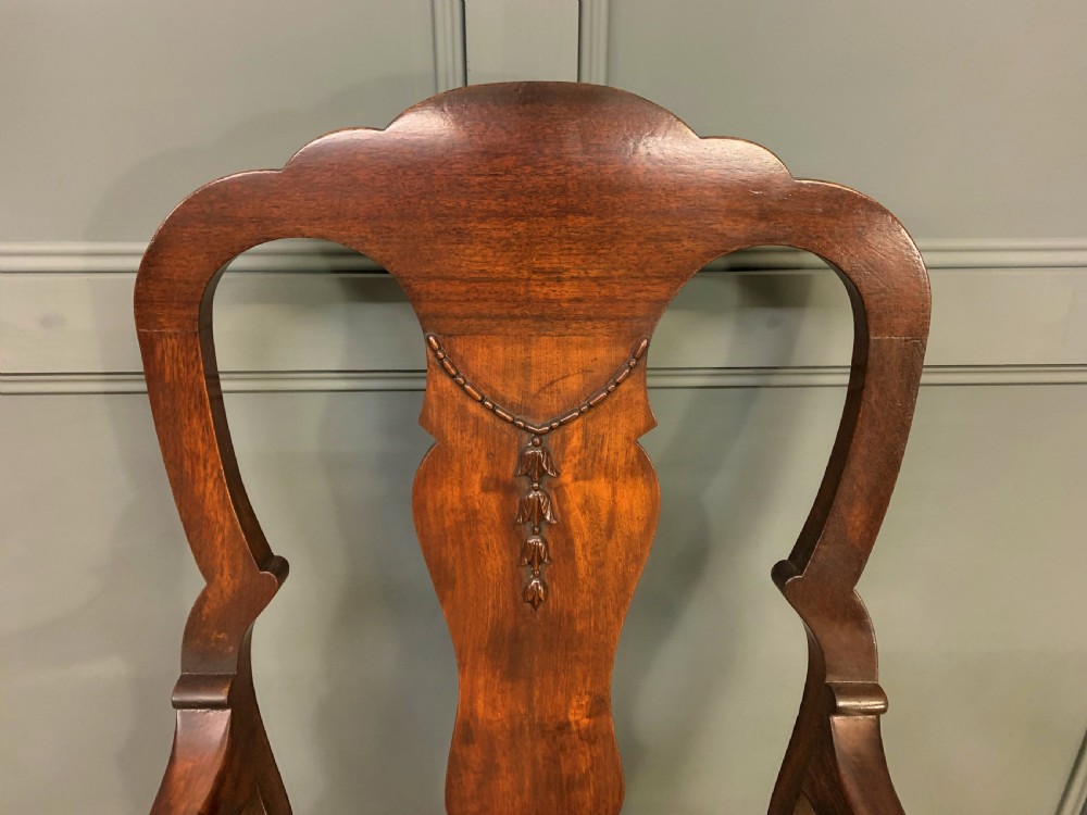A walnut high-back armchair featuring a carved back splat, reddish-brown leather seat, shaped arms, and carved cabriole legs ending in claw and ball feet. View V