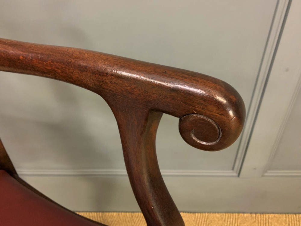 A walnut high-back armchair featuring a carved back splat, reddish-brown leather seat, shaped arms, and carved cabriole legs ending in claw and ball feet. View VII