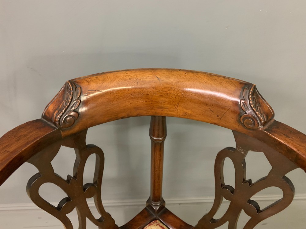 A Georgian style walnut corner chair with a curved crest rail, pierced back splats, a tapestry seat pad, and a central cabriole front leg ending in a claw and ball foot. View II