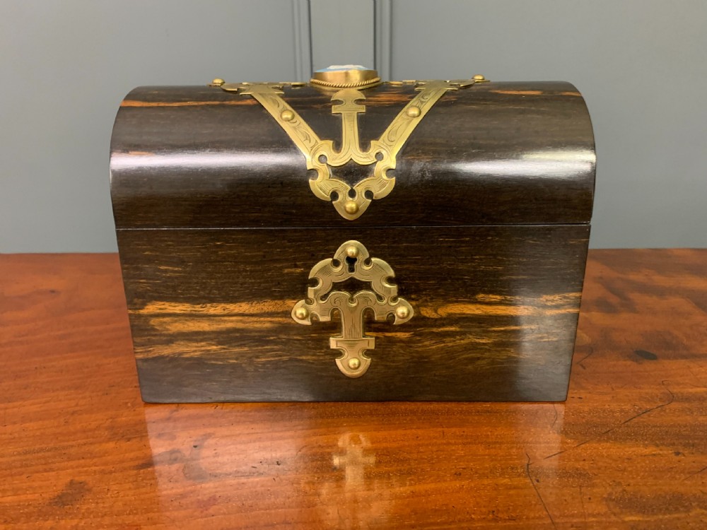 A Victorian dome-topped stationery casket crafted from dark variegated coromandel wood, decorated with pierced brass strapwork and a blue and white ceramic cameo inset. View III
