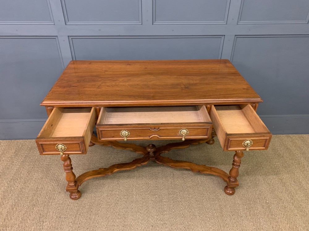A rectangular walnut side table featuring three drawers with brass teardrop drop-handles, spiral barley twist legs, and a serpentine X-stretcher with a central turned finial. View IX