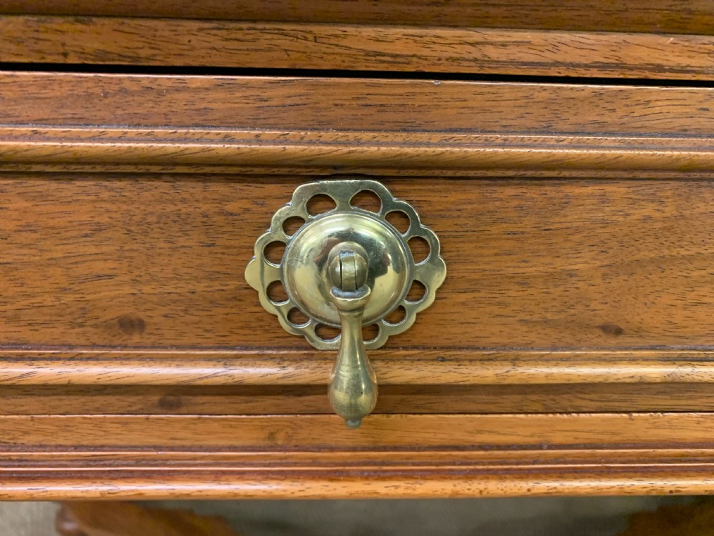 A rectangular walnut side table featuring three drawers with brass teardrop drop-handles, spiral barley twist legs, and a serpentine X-stretcher with a central turned finial. View X