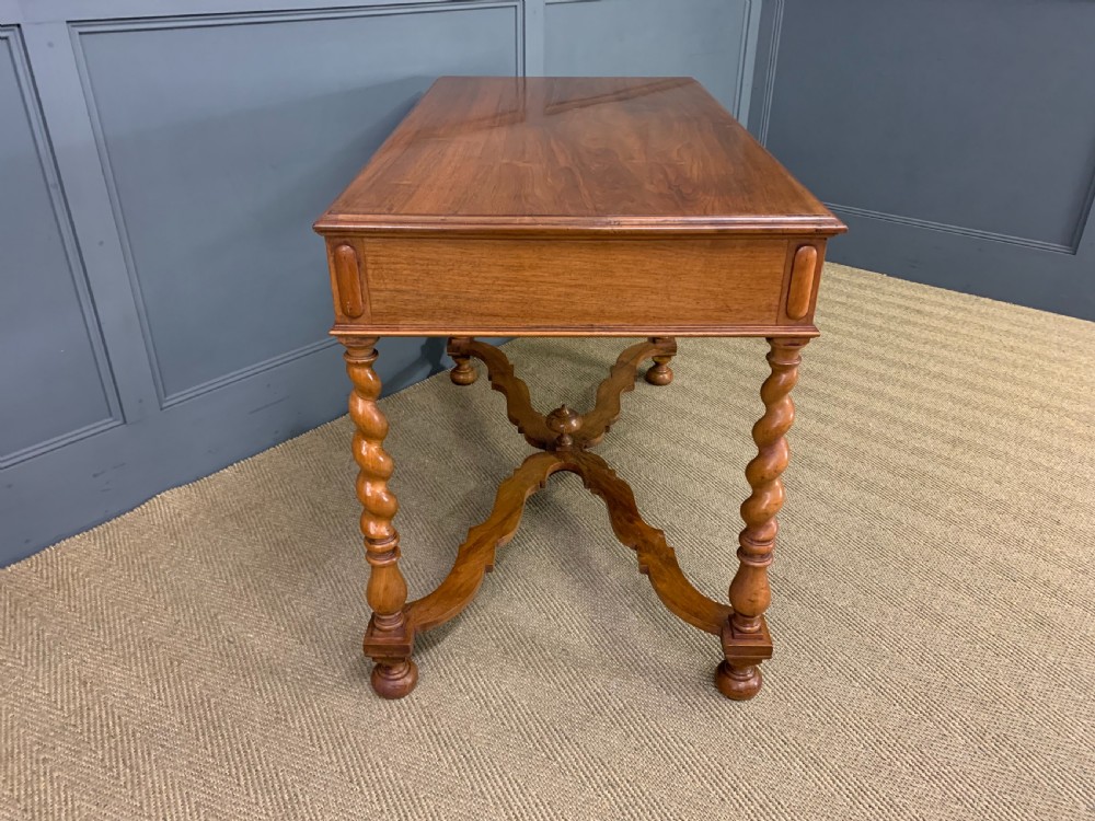 A rectangular walnut side table featuring three drawers with brass teardrop drop-handles, spiral barley twist legs, and a serpentine X-stretcher with a central turned finial. View XIII