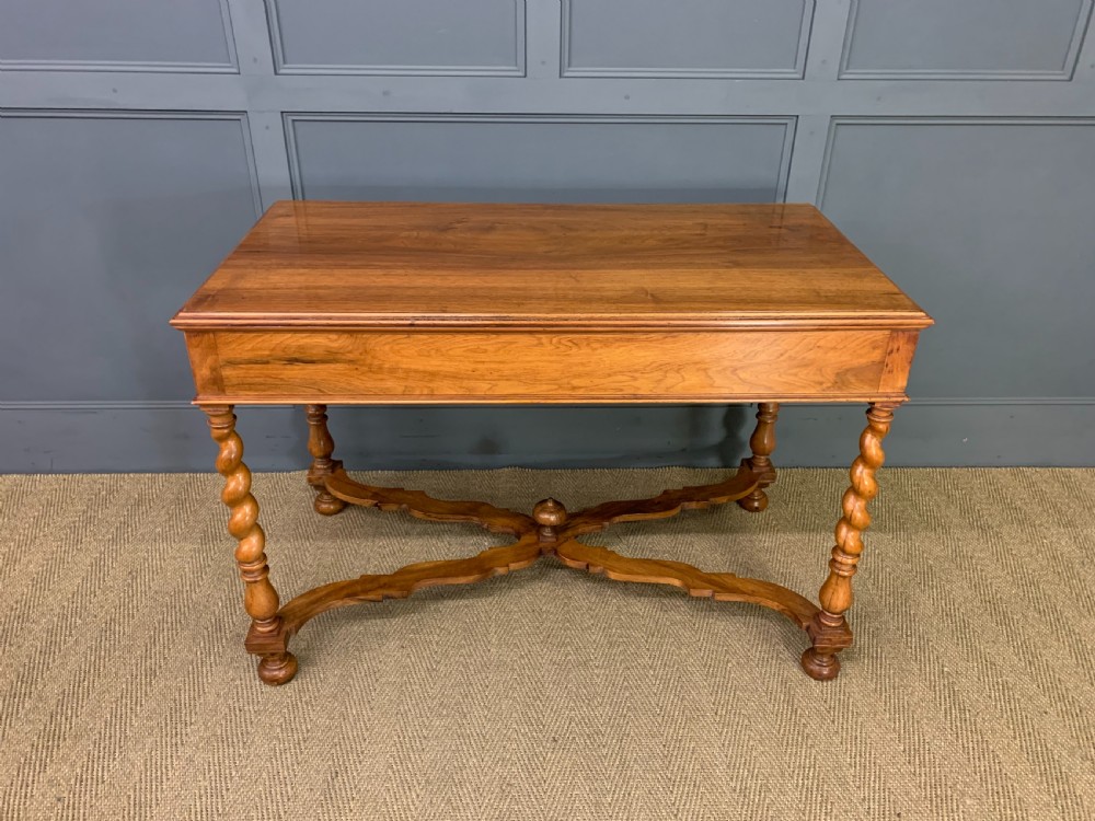 A rectangular walnut side table featuring three drawers with brass teardrop drop-handles, spiral barley twist legs, and a serpentine X-stretcher with a central turned finial. View XVIII