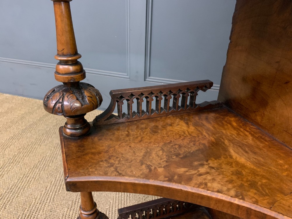 A Victorian burr walnut chiffonier featuring a central cabinet door with floral marquetry, open side tiers with turned spindles, and an upper structure with mirror panels and gallery railings. View XIV