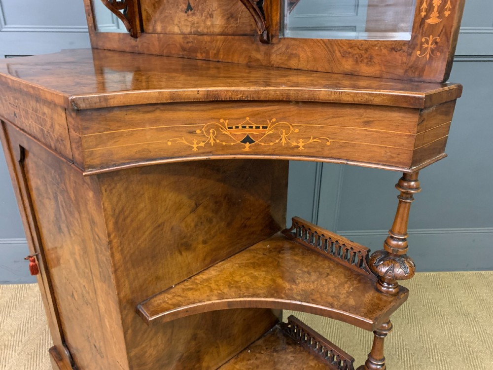 A Victorian burr walnut chiffonier featuring a central cabinet door with floral marquetry, open side tiers with turned spindles, and an upper structure with mirror panels and gallery railings. View XVIII