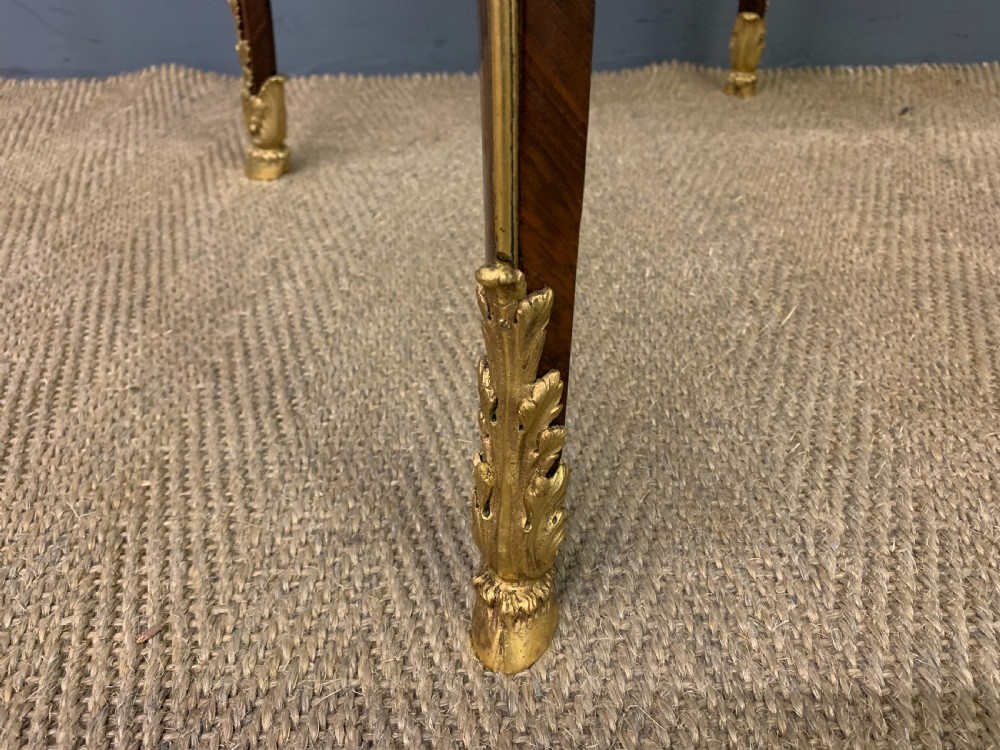 A circular French Louis XV revival centre table featuring quartered rosewood veneers, brass moulding rim, and gilt-bronze mounts on cabriole legs. View VIII
