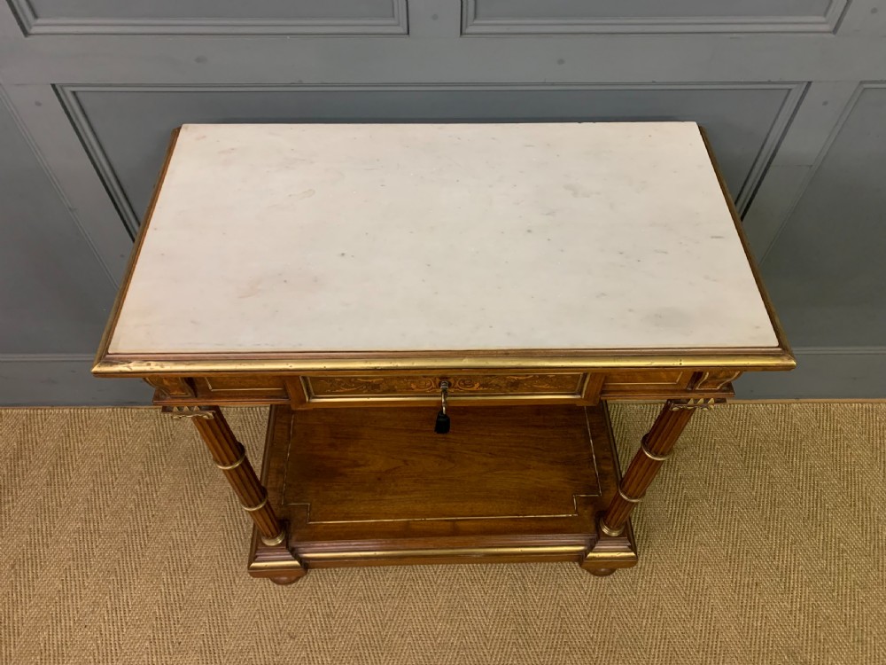 A 19th-century walnut pier table featuring a white marble top, inlaid floral and urn marquetry, fluted front columns with gilt mounts, and a lower open shelf. View III