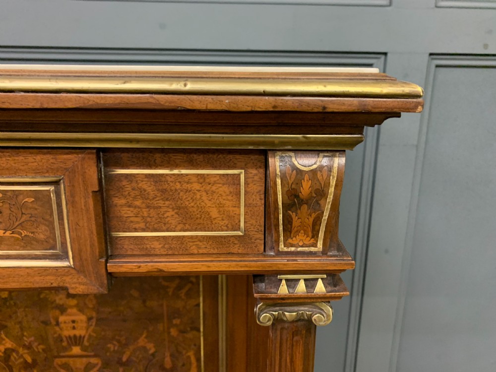 A 19th-century walnut pier table featuring a white marble top, inlaid floral and urn marquetry, fluted front columns with gilt mounts, and a lower open shelf. View VI