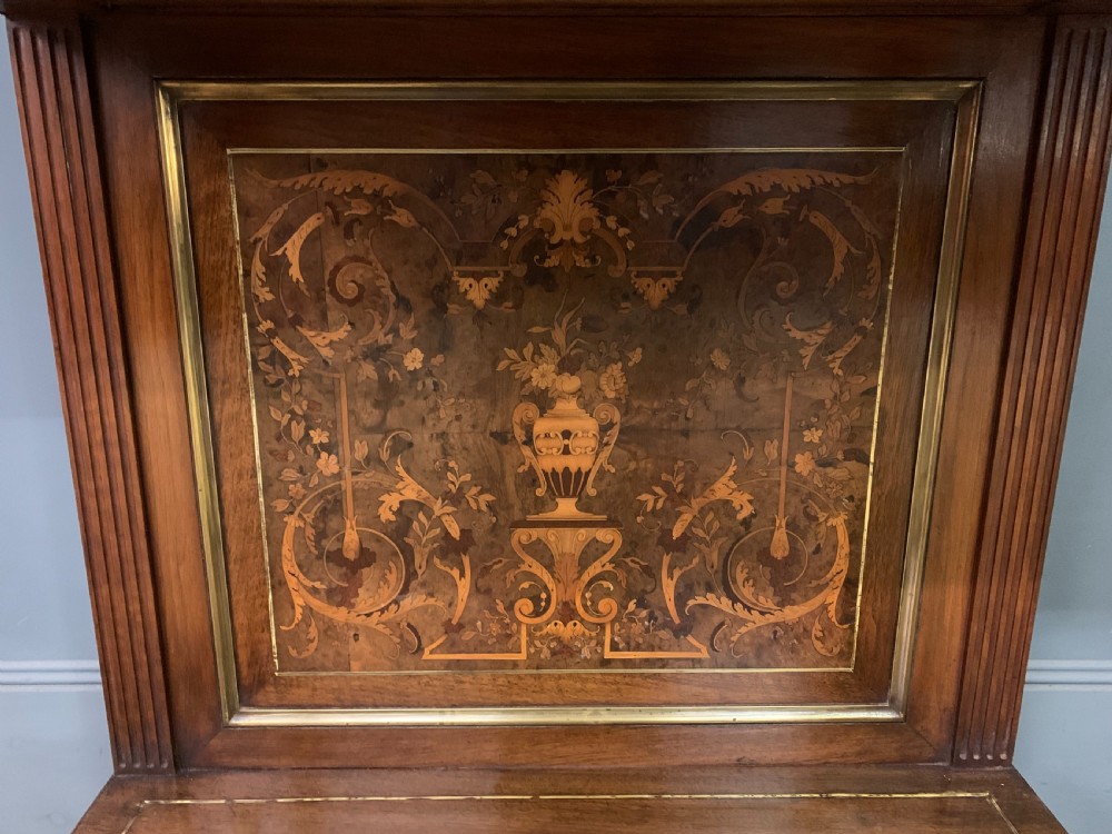 A 19th-century walnut pier table featuring a white marble top, inlaid floral and urn marquetry, fluted front columns with gilt mounts, and a lower open shelf. View VII