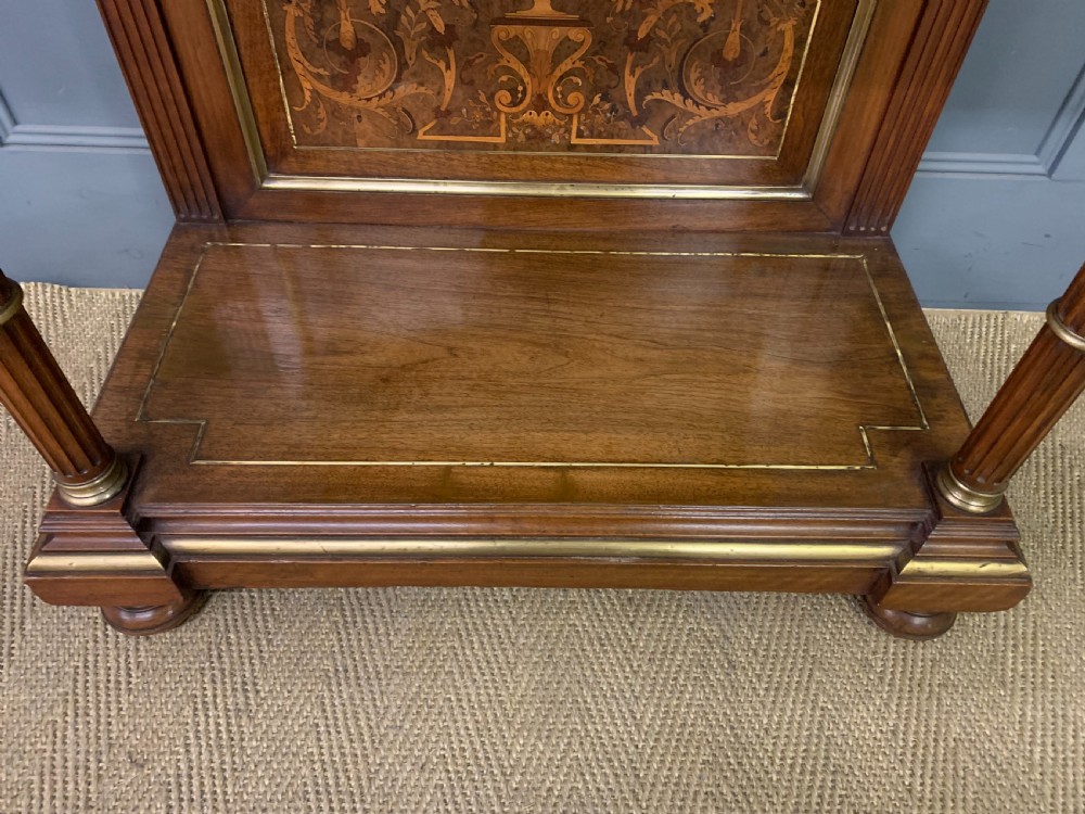 A 19th-century walnut pier table featuring a white marble top, inlaid floral and urn marquetry, fluted front columns with gilt mounts, and a lower open shelf. View VIII