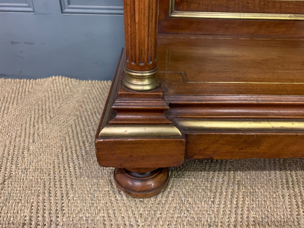 A 19th-century walnut pier table featuring a white marble top, inlaid floral and urn marquetry, fluted front columns with gilt mounts, and a lower open shelf. View IX