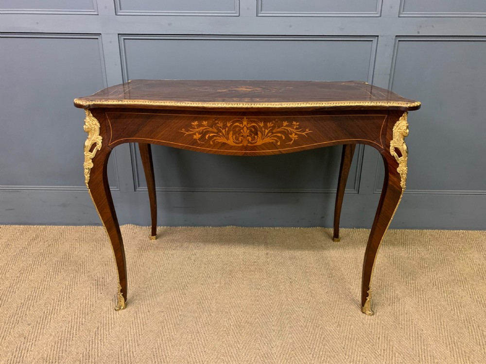 An antique rosewood occasional table featuring floral marquetry inlays across the serpentine top and apron, supported by cabriole legs with gilt-bronze ormolu mounts. View II