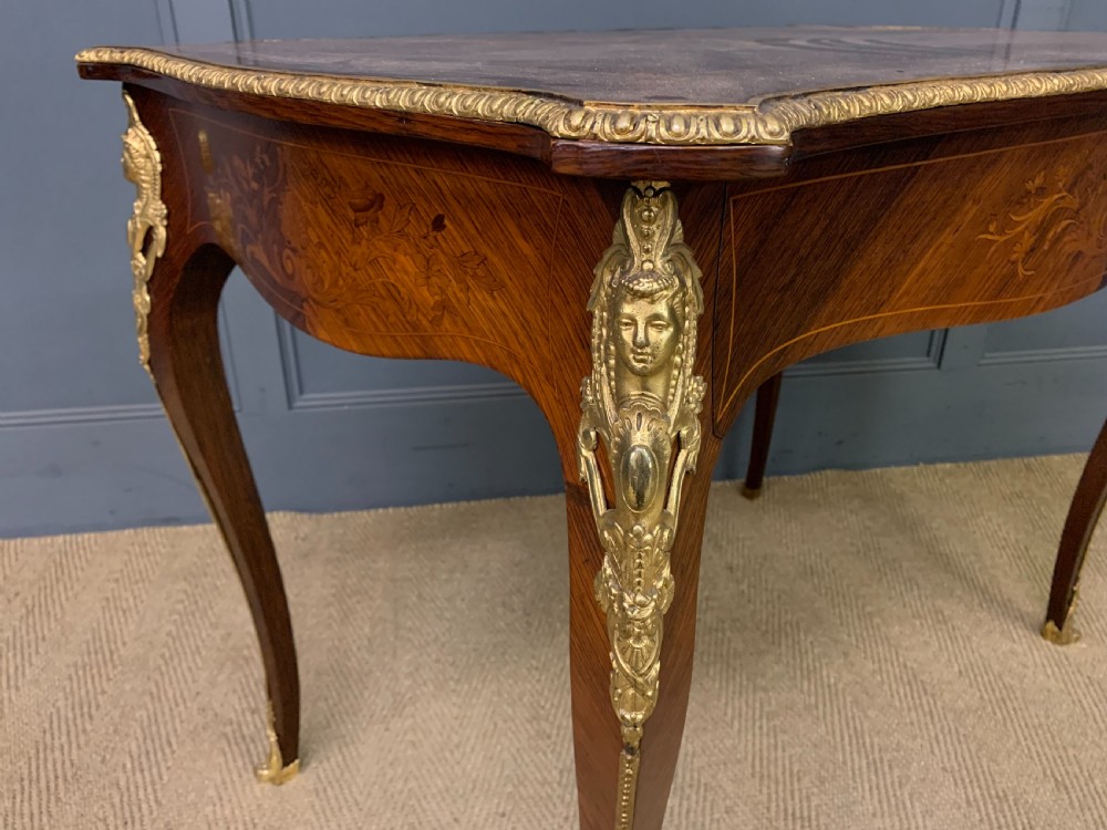 An antique rosewood occasional table featuring floral marquetry inlays across the serpentine top and apron, supported by cabriole legs with gilt-bronze ormolu mounts. View VII