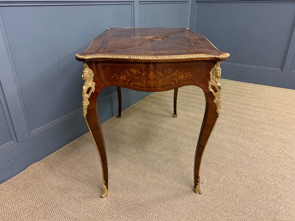 An antique rosewood occasional table featuring floral marquetry inlays across the serpentine top and apron, supported by cabriole legs with gilt-bronze ormolu mounts. View IX