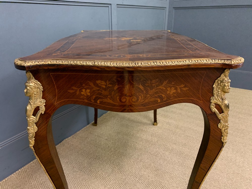An antique rosewood occasional table featuring floral marquetry inlays across the serpentine top and apron, supported by cabriole legs with gilt-bronze ormolu mounts. View X