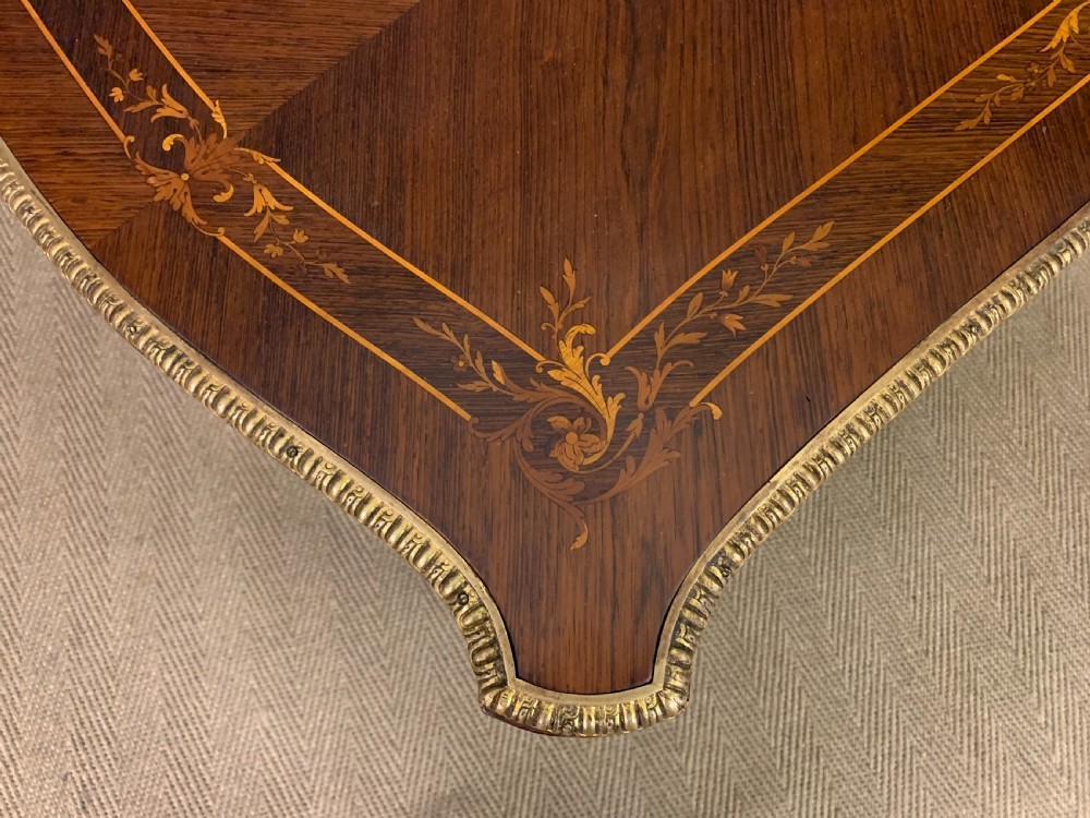 An antique rosewood occasional table featuring floral marquetry inlays across the serpentine top and apron, supported by cabriole legs with gilt-bronze ormolu mounts. View XI