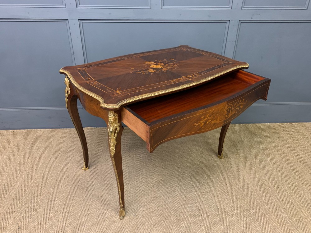 An antique rosewood occasional table featuring floral marquetry inlays across the serpentine top and apron, supported by cabriole legs with gilt-bronze ormolu mounts. View XII