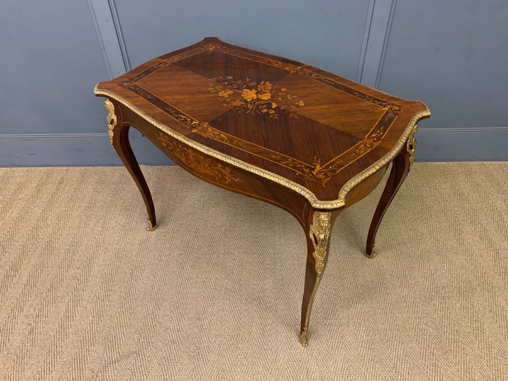 An antique rosewood occasional table featuring floral marquetry inlays across the serpentine top and apron, supported by cabriole legs with gilt-bronze ormolu mounts. View XIII